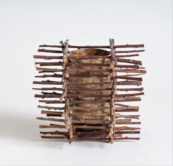 Birch bark pot clad in twig tower